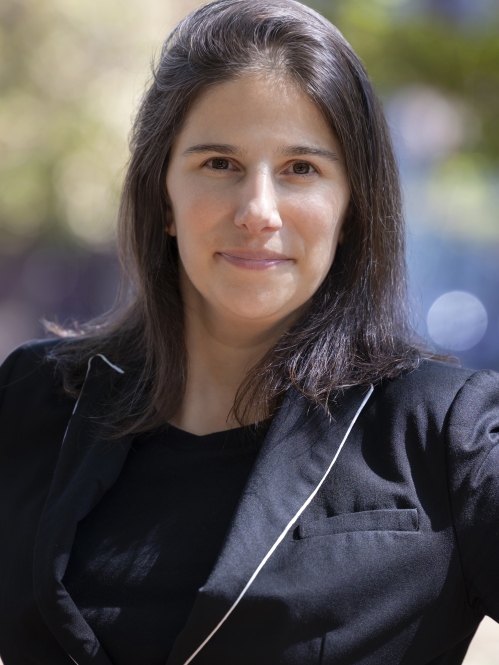 Woman grinning wearing black shirt and black jacket