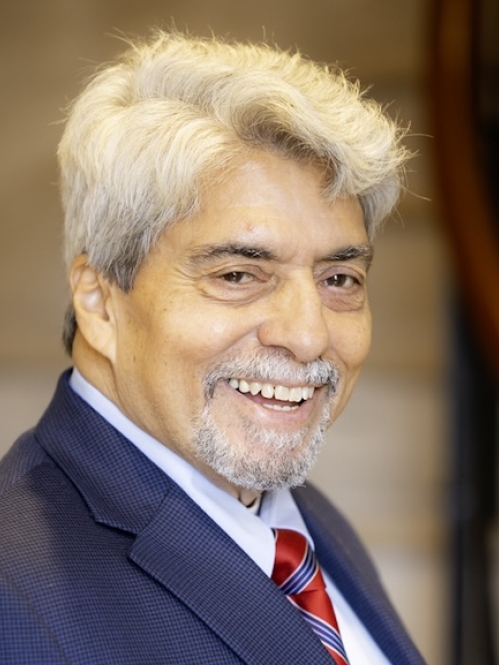 Man in blue suit smiling