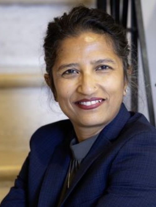 woman smiling and sitting on stairs