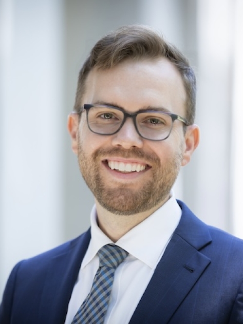 man in blue suit smiling