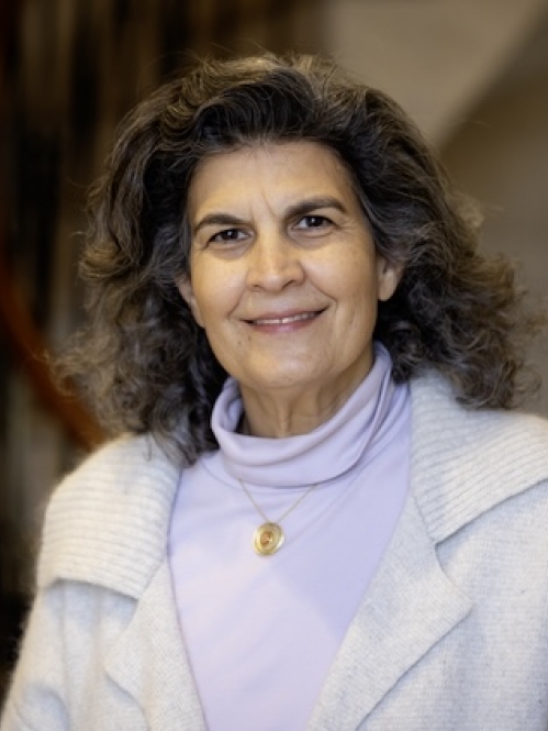 woman in front of staircase wearing white jacket