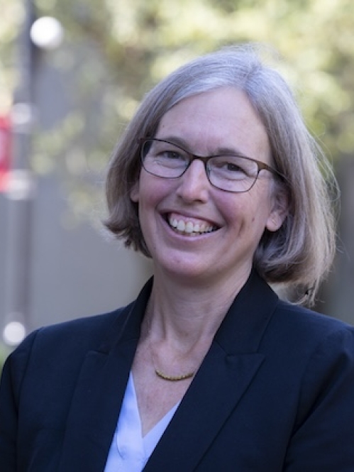 woman outside wearing glasses and smiling