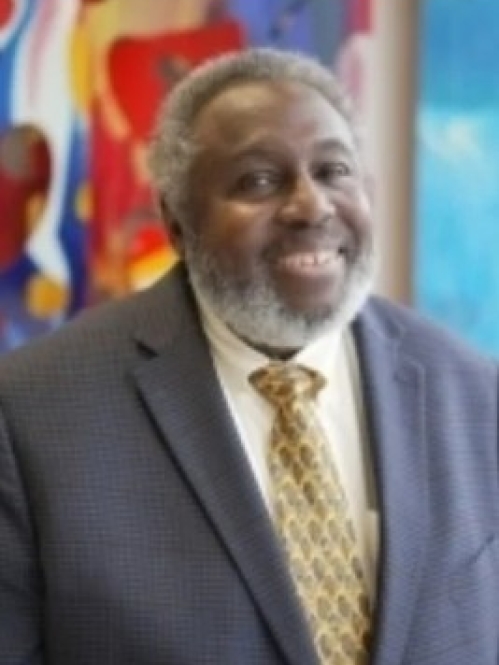 Man smiling wearing yellow patterned tie
