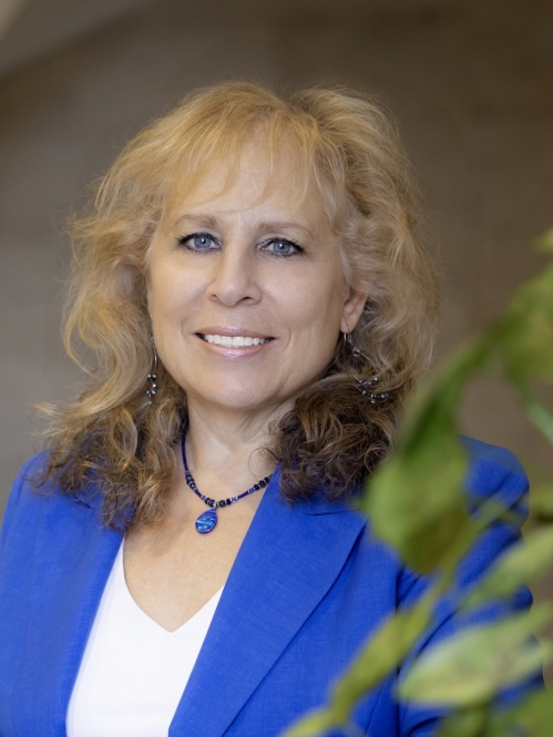 woman smiling in blue blazer