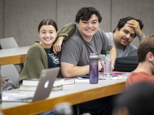Three students smiling in class