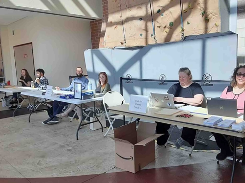Attorneys seated at long tables with laptops