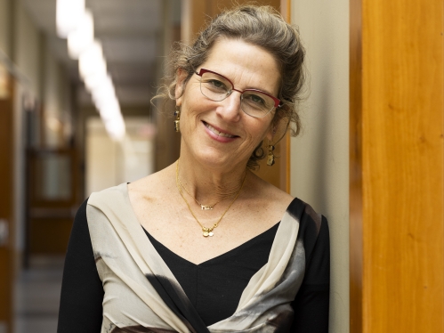 a woman with glasses smiling