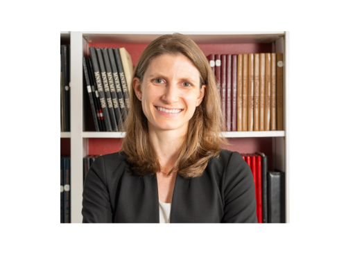 woman smiling in front of bookcase