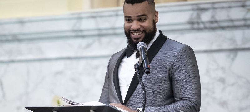 Man smiling at podium