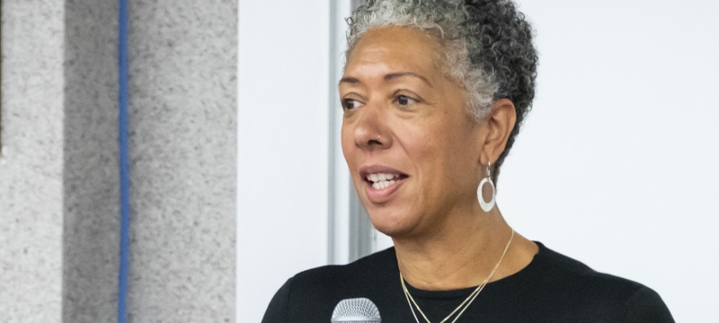 Woman speaking on mic at podium