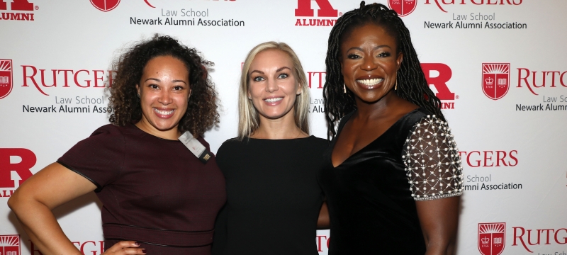 Three women standing and smiling