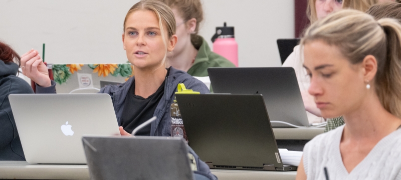women in front of laptops in classroom