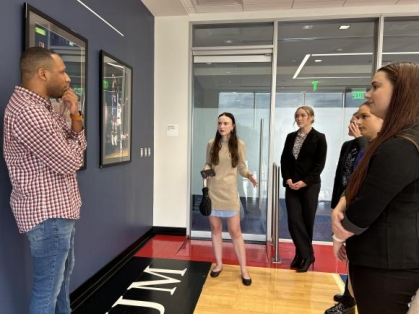 group of people standing and speaking to one another