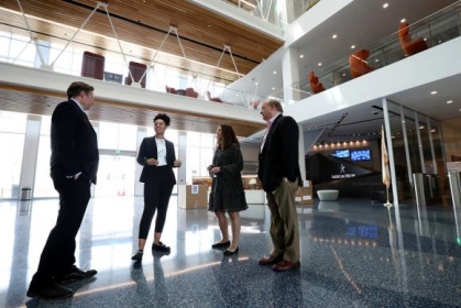 Group of people standing and speaking with each other