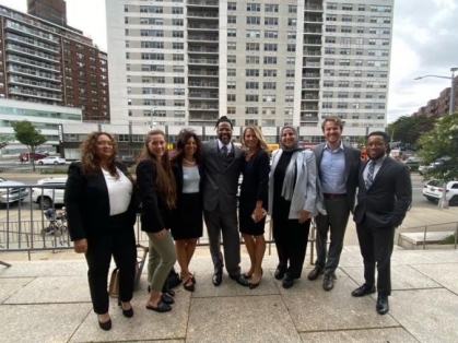 Group of people in suits posing for a photograph
