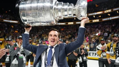 man holding a large trophy above his head