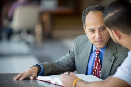 man in a suit talking to another person