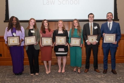 group of people holding awards and posing for a photograph