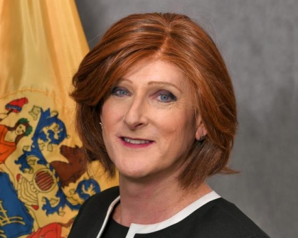 woman in a suit posing for a photograph