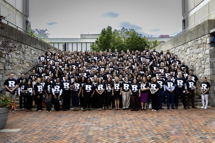 large group on steps wearing black and white tshirts