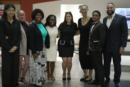 mend and women standing side by side in business attire and smiling