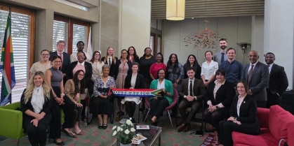 large group of people sitting and standing and smiling