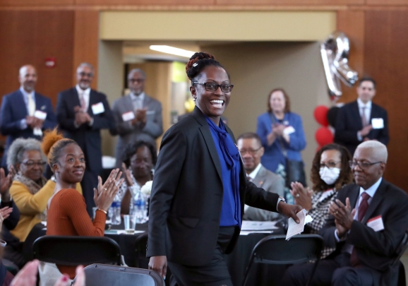 Woman walking and smiling at event