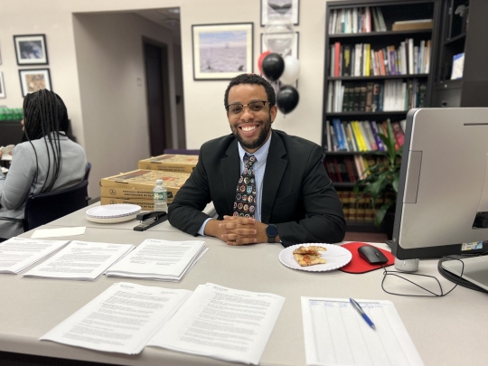 Student at desk smiling