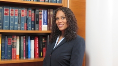 Deanna Christian RLAW'17 stands in a law library.