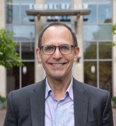 man wearing glasses and smiling