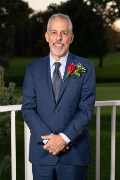 man in a suit posing for a photograph