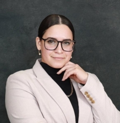 woman in a suit posing for a photograph