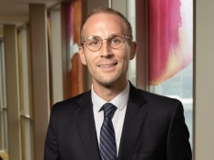 man in a suit posing for a photograph