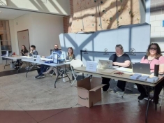 people sitting at tables looking at their computers