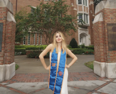 woman in blue college sash with hands on hips
