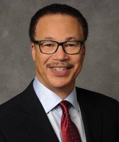 man in a suit posing for a photograph