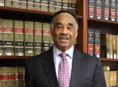 man in a suit posing for a photograph