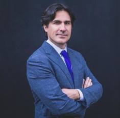 man in a suit posing for a photograph