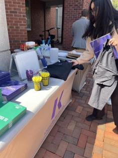 woman grabbing an item from a table