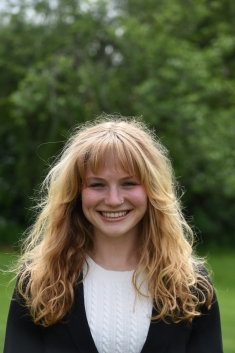 woman in field smiling