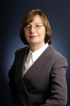 woman in a suit posing for a photograph