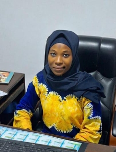 woman at a desk posing for a photograph