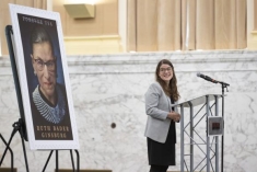 woman speaking behind a podium