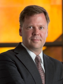 man in a suit posing for a photograph