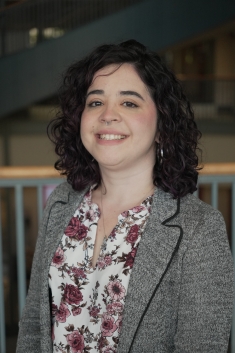 woman smiling in gray blazer