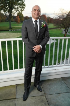 man in a suit posing for a photograph
