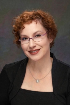 woman in a suit posing for a photograph