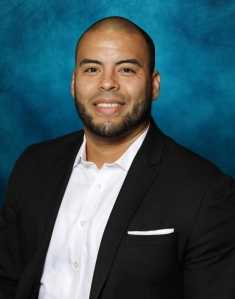man in a suit posing for a photograph