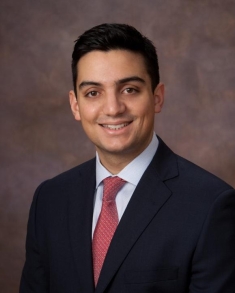 man in a suit posing for a photograph