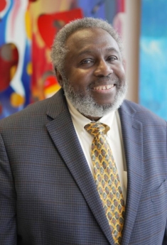 man in a suit posing for a photograph